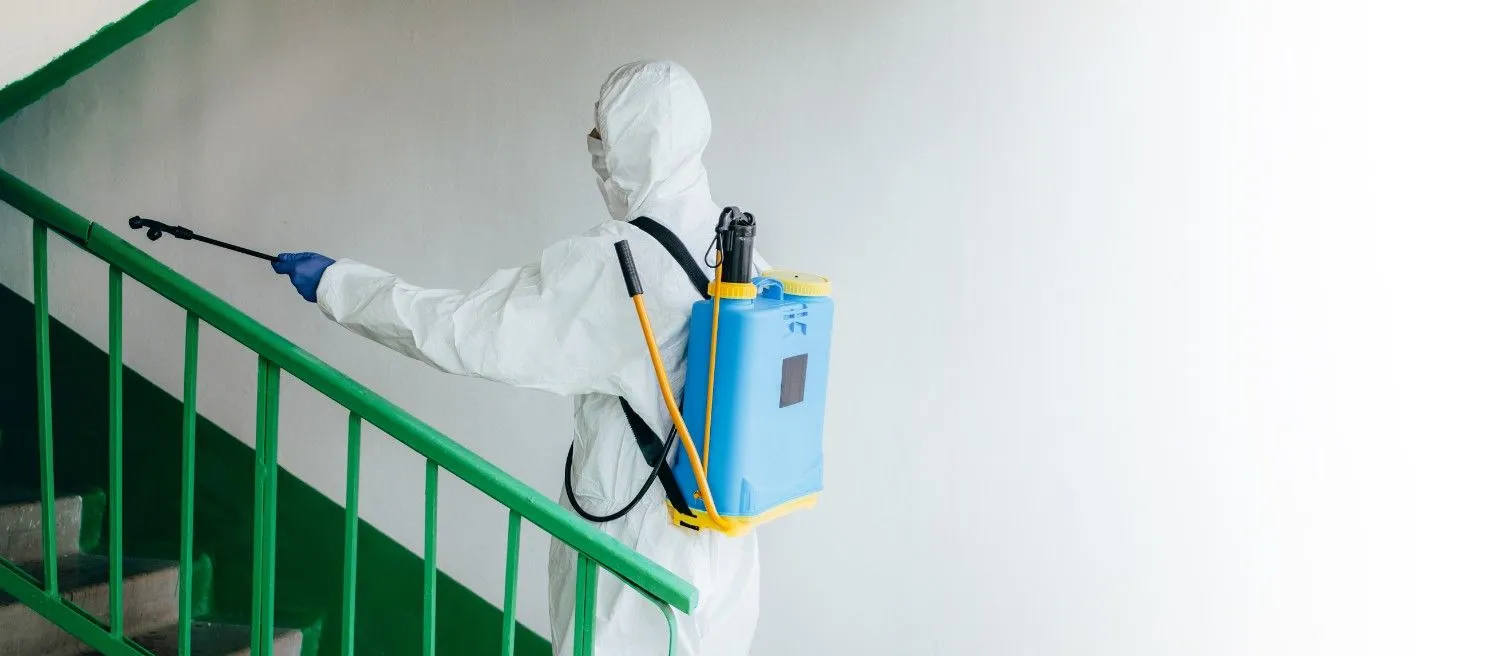 Pest Defenses technician spraying outdoors